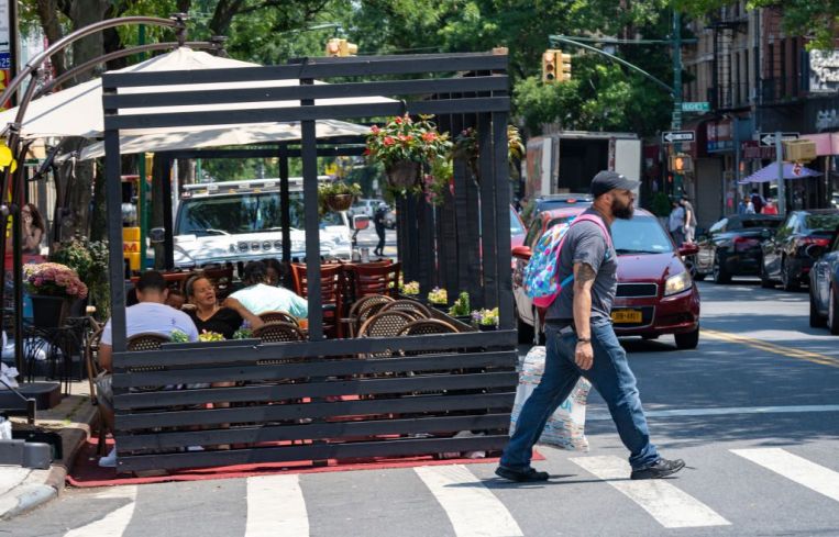 People eat at a cafe during the lunch rush on July 6, 2020 in the Bronx borough of New York City.