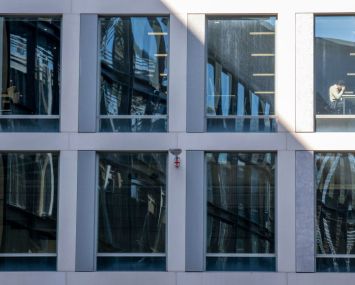 An office worker viewable in window.