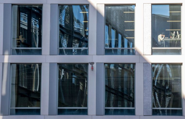 An office worker viewable in window.