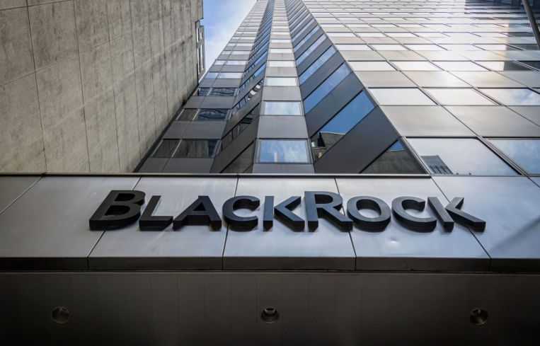 A large skyscraper ascends into the blue sky with the name "BlackRock" on the lowest level.