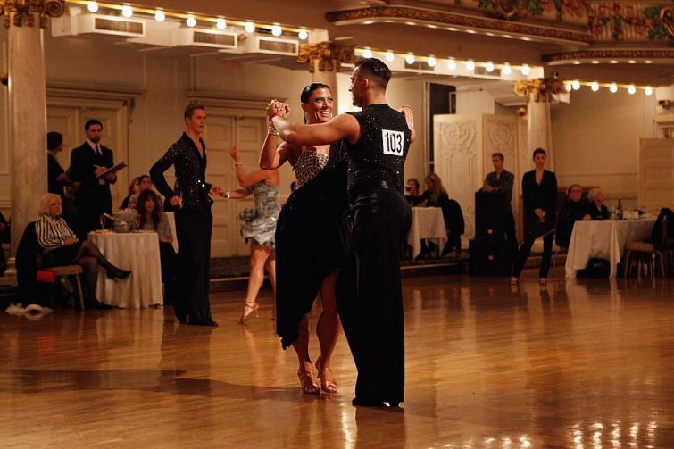 Two dancers, a woman in a black dress and a man in a vest, in Grand Prospect hall in 2011.