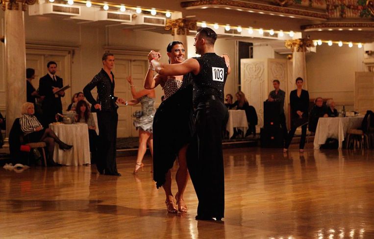 Two dancers, a woman in a black dress and a man in a vest, in Grand Prospect hall in 2011.