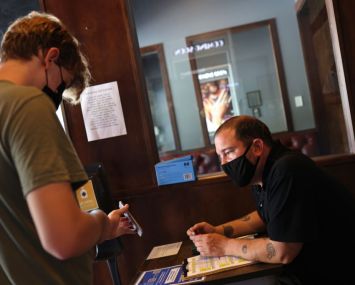 Employee checks a vaccination card