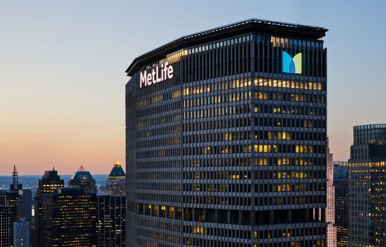 The top of a large skyscraper with the word "MetLife" in glowing letters on the top.