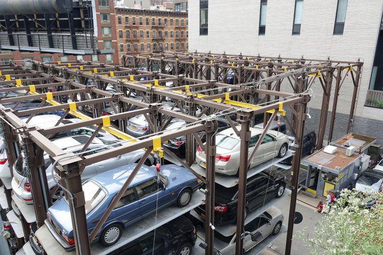 Cars stacked at a mechanical parking deck.