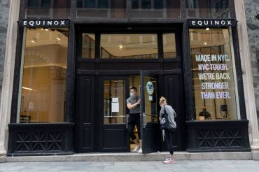 A man wearing a mask walks out of a newly reopened Equinox location as the city continues Phase 4 of re-opening following restrictions imposed to slow the spread of coronavirus on September 02, 2020 in New York City. Gyms reopened with new guidelines on September 02, 2020 after Mayor Bill de Blasio delayed their initial reopening.