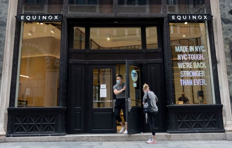 A man wearing a mask walks out of a newly reopened Equinox location as the city continues Phase 4 of re-opening following restrictions imposed to slow the spread of coronavirus on September 02, 2020 in New York City. Gyms reopened with new guidelines on September 02, 2020 after Mayor Bill de Blasio delayed their initial reopening.