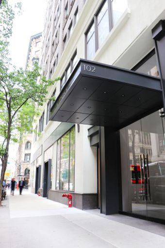 The overhead black awning of 102 Madison Avenue.