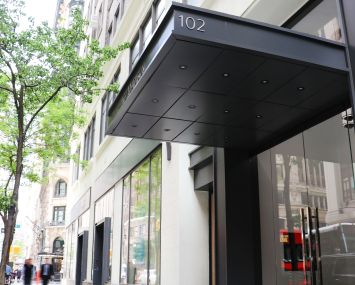 The overhead black awning of 102 Madison Avenue.