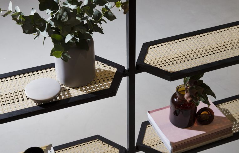 Custom-built shelves help separate the common areas from the desk work space.