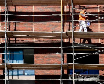 Seven-story scaffolds holding construction crews surround The Mark which features 165 apartments and 20,000 square feet of retail shops on the ground floor, under construction along Market Street in Riverside, Calif. in October, 2021.