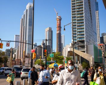 Pedestrians walk near new apartment buildings and shopping areas on September 24, 2021 in the Brooklyn borough of New York City. The average rent for a 2-bedroom apartment in June 2001 in Brooklyn is $3,000 per month, $350 less per month than in June 2020 in the middle of the Covid-19 pandemic. (Photo by Robert Nickelsberg/Getty Images)