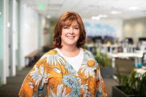 A woman in an office smiling.