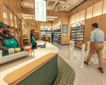 Customers mill about A cashierless Starbucks store.