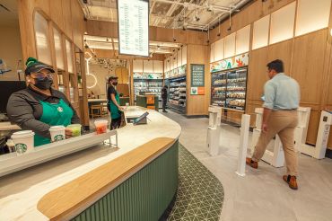 Customers mill about A cashierless Starbucks store.
