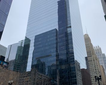 Looking up at a shiny tower.