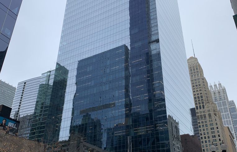 Looking up at a shiny tower.