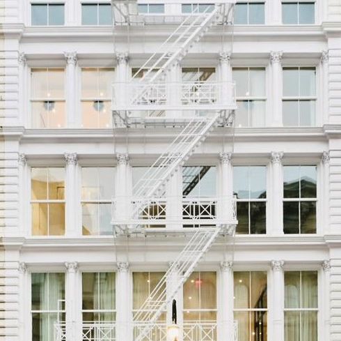 A white building with a fire escape.