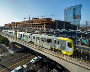 The Cumulus District project under construction behind the Metro Expo Line light rail station. The second phase of the Expo Line was completed in 2016, extending approximately six miles from Culver City to Santa Monica.