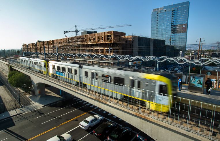 The Cumulus District project under construction behind the Metro Expo Line light rail station. The second phase of the Expo Line was completed in 2016, extending approximately six miles from Culver City to Santa Monica.
