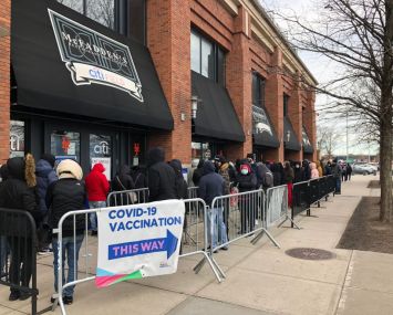 People queue up outside a COVID-19 vaccination site in the Queens borough on December 23, 2021 in New York City.