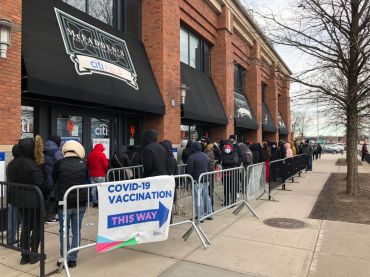People queue up outside a COVID-19 vaccination site in the Queens borough on December 23, 2021 in New York City.