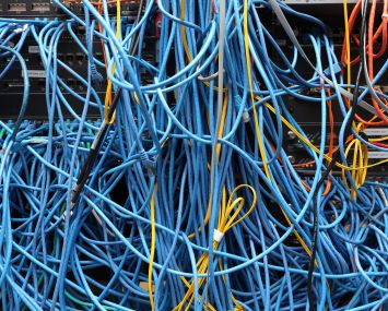 Clumps of cords plugged into the wall.