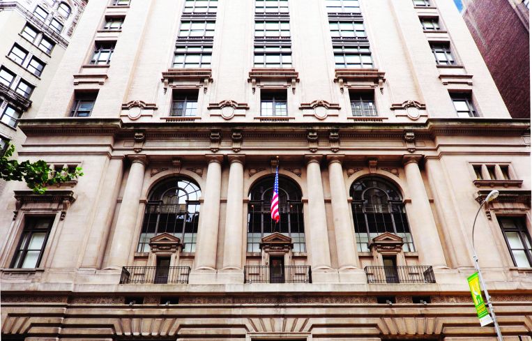 The large tan building at 25 West 39th Street from an angle looking upwards.