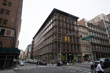 The large brown rectangular building at 529 Broadway, seen from its corner.