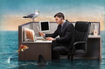 An illustration of a man at an office cubicle as the floor around him floods with water, sharks and fish.