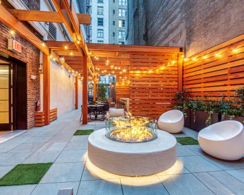 SJP Properties turned an unused rear yard into an outdoor amenity space with a firepit, seating and a bar.