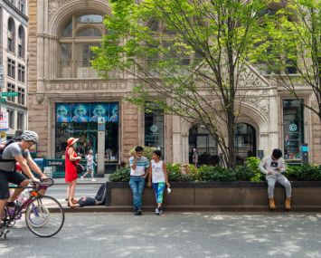People rest on a traffic island along Park Avenue during Summer Streets by the New York City Department of Transportation on Aug. 07, 2021 in New York City.