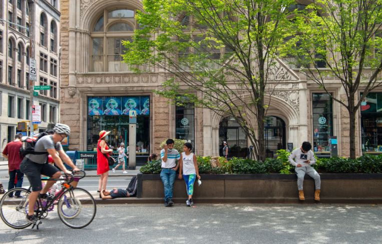 People rest on a traffic island along Park Avenue during Summer Streets by the New York City Department of Transportation on Aug. 07, 2021 in New York City.