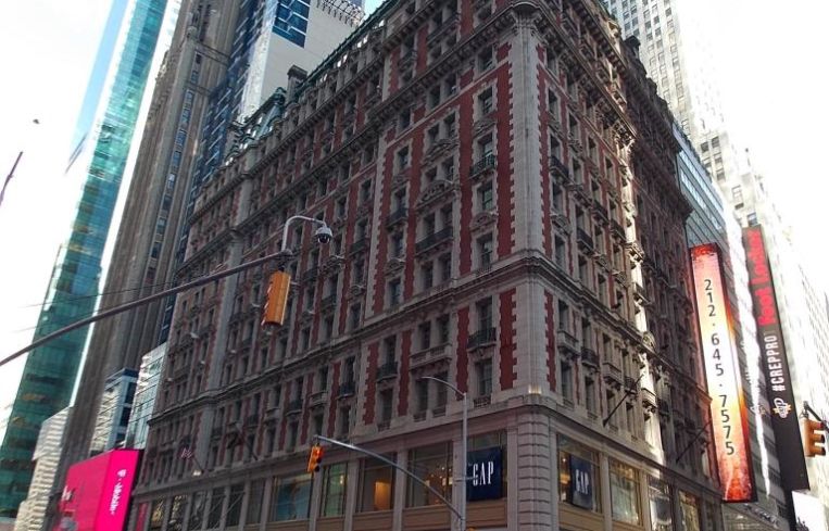 The large red and white brick commercial condo tower at 140 West 42nd Street.