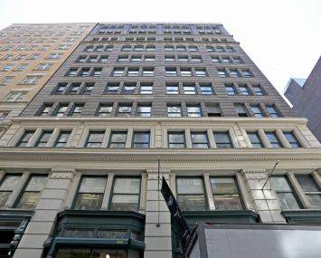 The large brown brick building at 22 West 19th Street rising upwards.