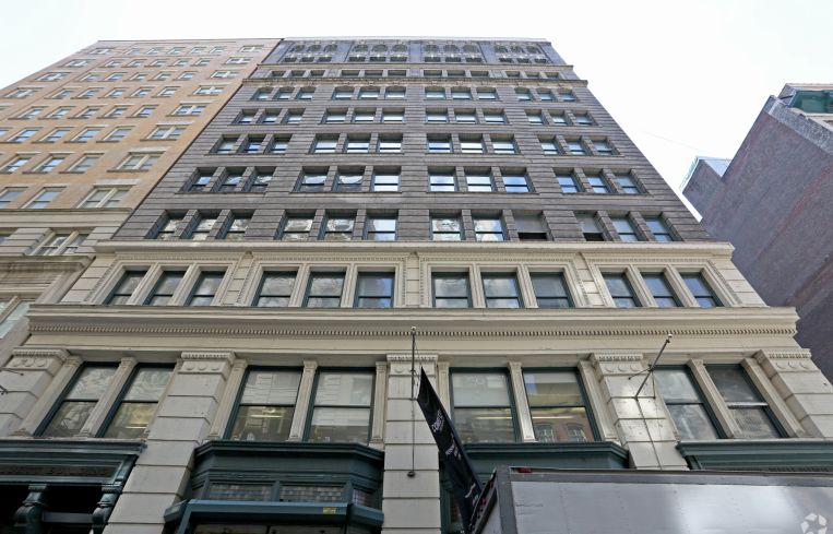 The large brown brick building at 22 West 19th Street rising upwards.