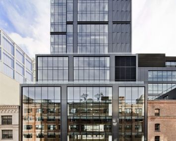 The large, dark grey building at 412 West 15th Street, covered in dark windows.