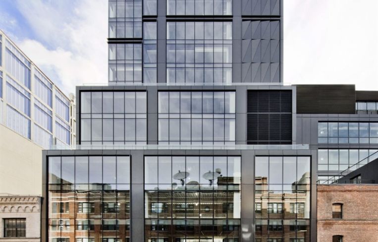 The large, dark grey building at 412 West 15th Street, covered in dark windows.