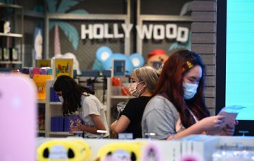 People shop at a store in Hollywood. The indoor mask mandate will be relaxed for vaccinated people on February 25
