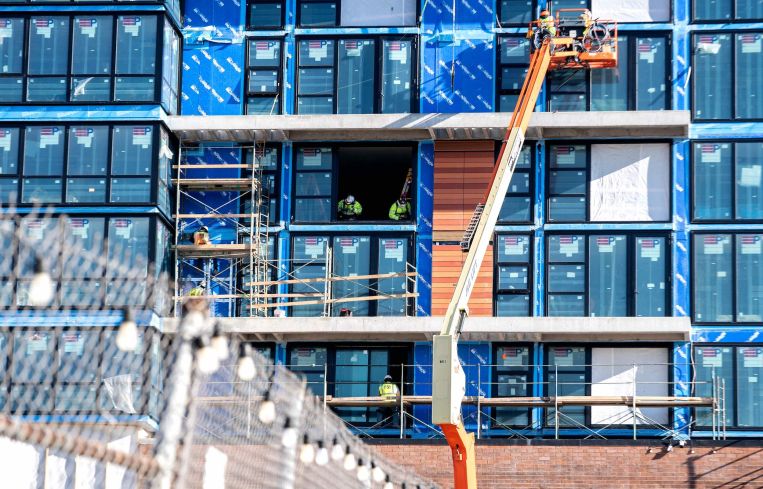 Construction workers work on a building near Union Market in Washington, DC, on February 9.