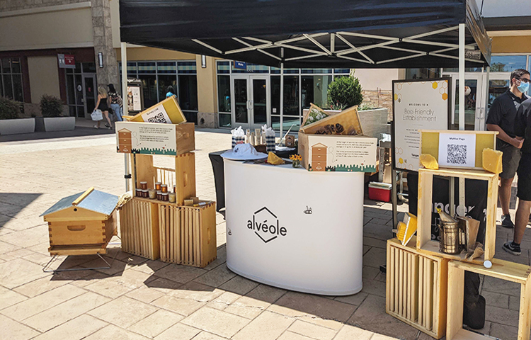 CO Alveole Outdoor information booth 750x480 How Urban Beekeeping Company Alvéole Became Essential to Commercial Building Owners