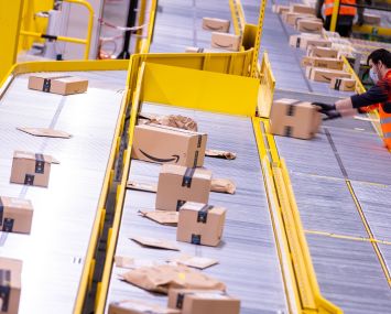 Employees sort parcels from online retailer Amazon at a new distribution center.