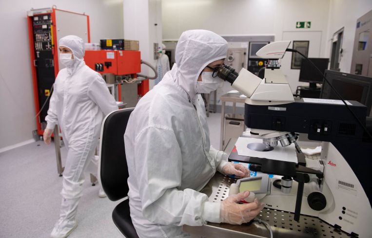 Employees work in a chip manufacturing process institute.