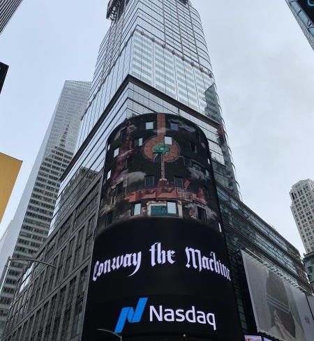 A NASDAQ sign in front of 151 West 42nd Street.