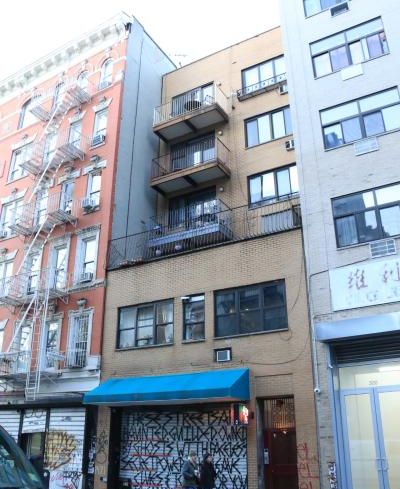 The brown, five-story building at 302 Broome Street.