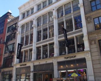 The white building at 480 Broadway with large windows.