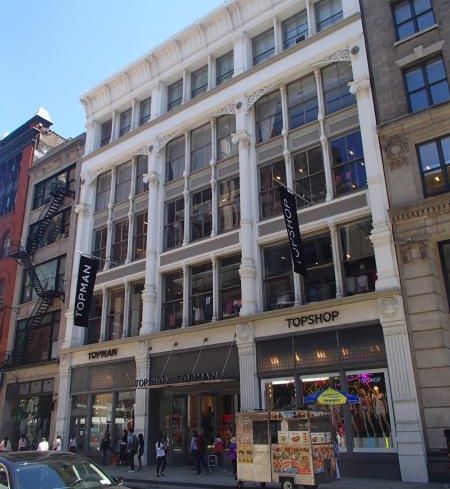 The white building at 480 Broadway with large windows.