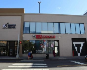 The strip mall building with a stretch of rectangular, second-floor windows at 7000 Austin Street.