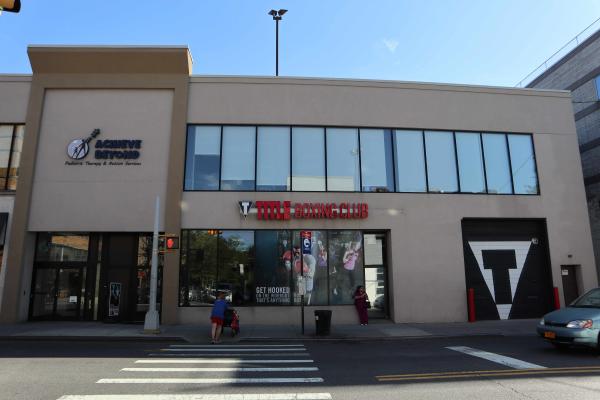 The strip mall building with a stretch of rectangular, second-floor windows at 7000 Austin Street.