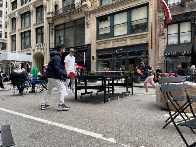 Two people play ping pong in the Flatiron District of Manhattan.